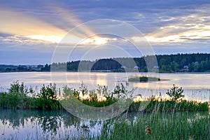 Morning mist on the lake in the sun