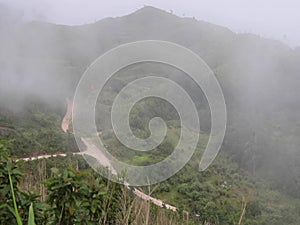 Morning mist landscape of mountain range in the green forest.