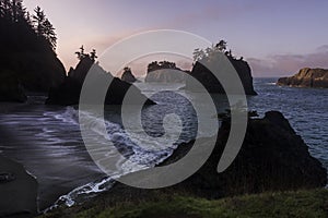 Morning mist over silhouetted rocky shoreline