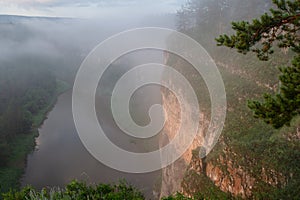 The morning mist rises over the river canyon