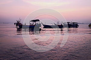 Morning mood with the sunrise at penang Malaysia where there is a boats near the beach