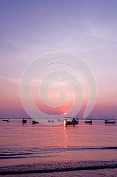 Morning mood with the sunrise at penang Malaysia where there is a boats near the beach