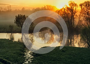 Morning. a picturesque foggy dawn by the river. Sun rays