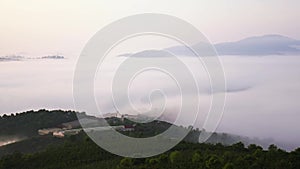 Morning in plateau covered with fog below hillside