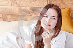 Morning portrait of young pensive pretty woman relaxing alone on bed