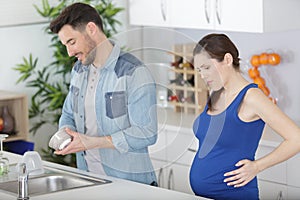 morning pregnant couple on kitchen