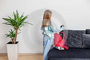 Morning preparation before school. Child prepares backpack for school. Back to school