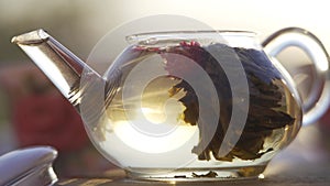 The morning rays of the sun illuminate. A teapot is visible in the background. The water in the kettle boils to make tea