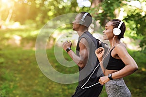 Morning Run Concept. Sporty Black Man And Woman Jogging Outdoor In Park