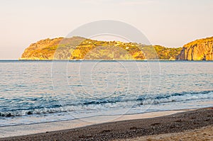 Morning sand beach on Tyrrhenian sea coast with mountains on background in Cilento Vallo di Diano and Alburni National park in