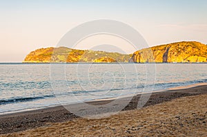 Morning sand beach on Tyrrhenian sea coast with mountains on background in Cilento Vallo di Diano and Alburni National park in