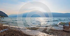 Morning scenery at the beach, tourist resort Gargnano, lake Garda, italy