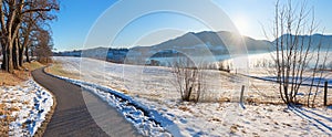 Morning scenery Kaltenbrunn, view to lake Tegernsee and bavarian alps, rests of snow at the fields