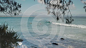 morning shot of longboard surfers at wategos beach of byron bay