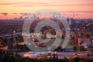 morning sky clouds in Toronto city, Canada. Rays of early rising sun. Landscape aerial top view with urban street.