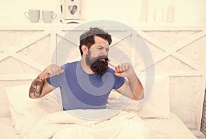 Morning sleepiness. peaceful mature male relaxing. bearded man stretching in bed. sleepy guy relax in bedroom. early photo