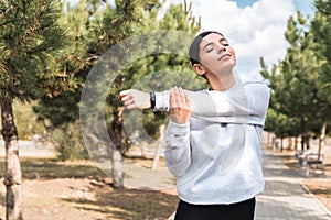 Morning stretches. cheerful young woman stretching in park before a run. healthy lifestyle and wellbeing