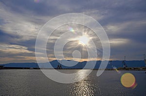 Morning sun over Rijeka port and industrial cranes on the pier, Croatia