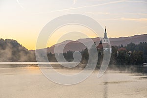 Morning sunrise beautiful lascape of Lake Bled with Alps at background and blue water