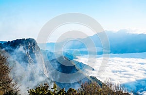 Morning sunrise, dramatic cloud of sea, giant rocks and Yushan mounatin under bright blue sky in AlishanAli mountain National Pa