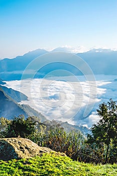 Morning sunrise, dramatic cloud of sea, giant rocks and Yushan mounatin under bright blue sky in AlishanAli mountain National Pa