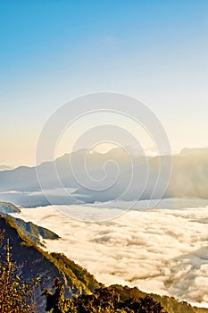 Morning sunrise, dramatic cloud of sea, giant rocks and Yushan mounatin under bright blue sky in AlishanAli mountain National Pa