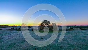 Morning sunrise over frost covered farm land