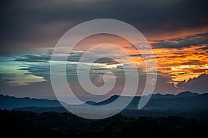 Morning sunrise over silhouetted mountains