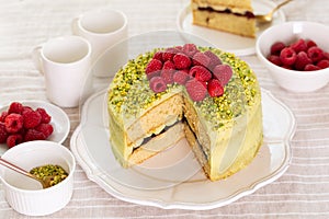 Morning table with Pistachio sponge cake and pistachio cream with raspberries.