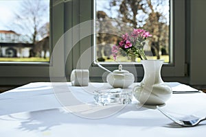 Morning table setting for breakfast from white tableware by the