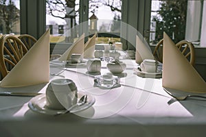 Morning table setting for breakfast from white tableware by the