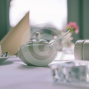 Morning table setting for breakfast from white tableware by the