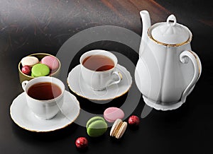 Morning tea - two tea mug with tea and macarons