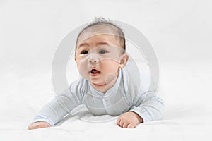 Morning Time.Adorable newborn kid during tummy time smiling happily at home.Portrait of cute smiling happy asian baby boy crawling
