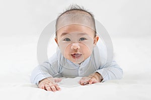 Morning Time.Adorable newborn kid during tummy time smiling happily at home.Portrait of cute smiling happy asian baby boy crawling