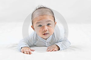 Morning Time.Adorable newborn kid during tummy time smiling happily at home.Portrait of cute smiling happy asian baby boy crawling