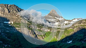 Morning time shot of mist clearing from mt oberlin and logan pass in glacier np