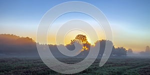 Morning twilight landscape with sunrise over autumn meadows