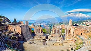 Morning view of ancient Greek theatre in Taormina on background of Etna Volcano, Sicily, Italy photo