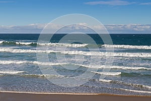 Morning view of the beach with breaking waves crashing sand on s