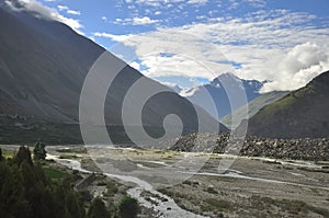 Morning view of mountains covered with clouds from the peak with Bhaga river in Darcha