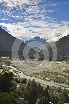 Morning view of mountains covered with clouds from the peak with Bhaga river in Darcha