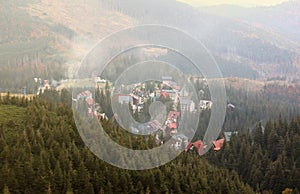 Morning view of residental area and houses around the Dragobrat mountain peaks in Carpathian mountains, Ukraine. Cloudy