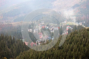 Morning view of residental area and houses around the Dragobrat mountain peaks in Carpathian mountains, Ukraine. Cloudy