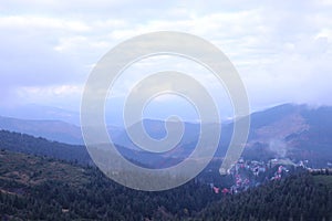 Morning view of residental area and houses around the Dragobrat mountain peaks in Carpathian mountains, Ukraine. Cloudy