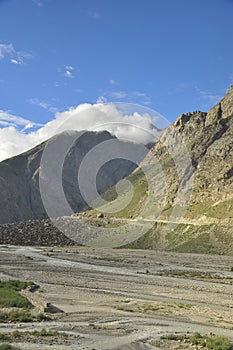 Morning view of rocky mountain covered with clouds from the top with Bhaga river in Darcha