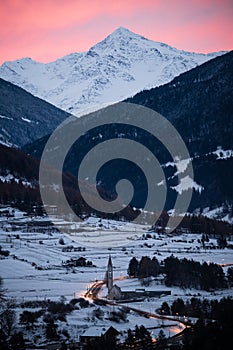 Morning view of snow covered mountains and village close to Bormio, Italy