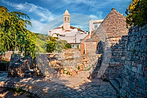 Morning view of strret with trullo trulli - traditional Apulian dry stone hut with a conical roof. Spring cityscape of Alberobe