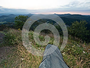 Morning wake up inn sleeping bag on mountain peak