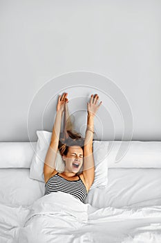 Morning Wake Up. Woman Waking Stretching In Bed. Healthy Lifestyle